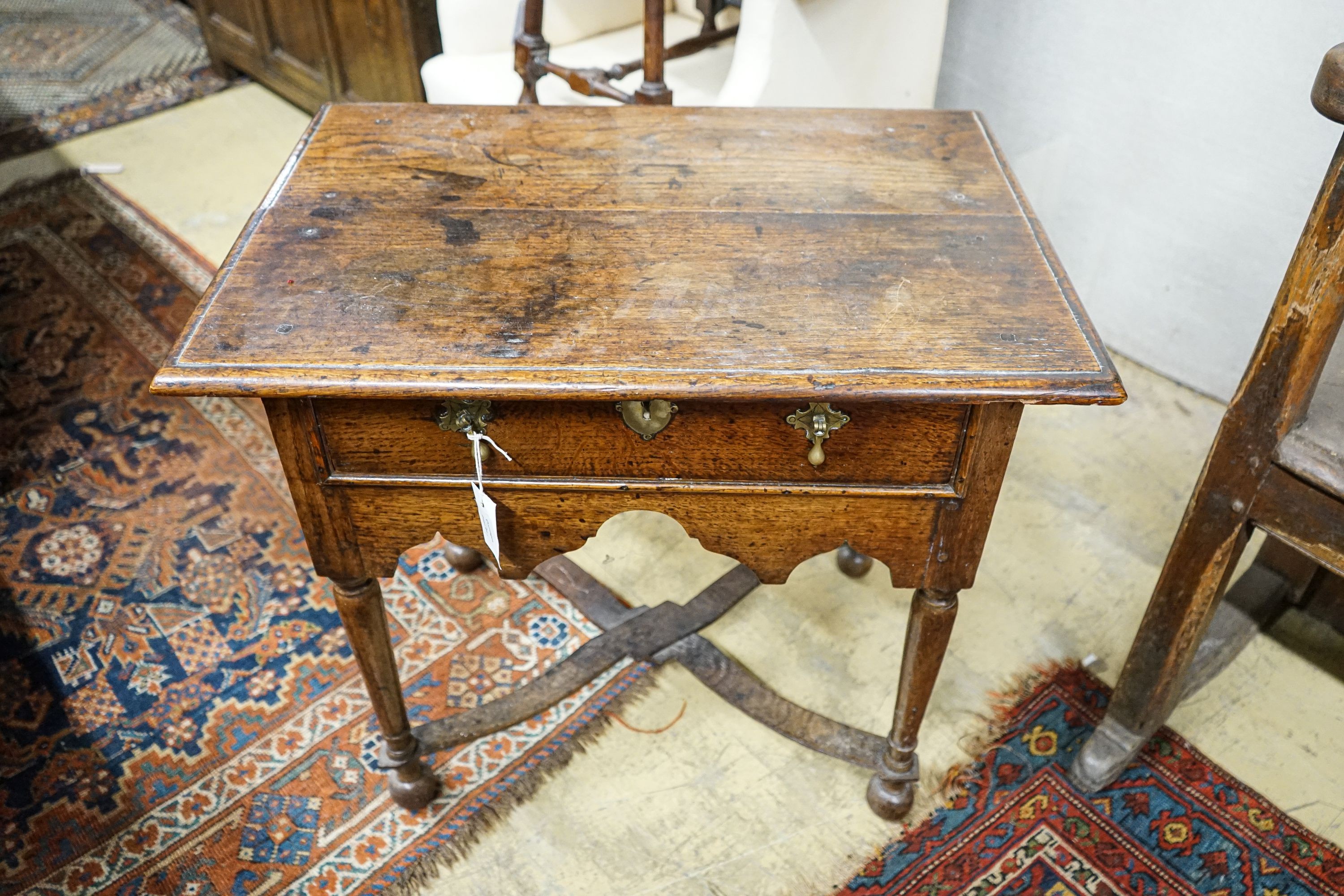 An early 18th century oak lowboy, with single drawer and saltire stretcher, width 67cm, depth 46cm, height 64cm
